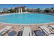 Large community swimming pool with lounge chairs and a pool-side clubhouse at 1533 Flange Dr, Davenport, FL 33896
