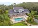 Aerial view of the home featuring a backyard pool with covered veranda at 1550 Bluewater Run, Chuluota, FL 32766