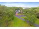 Desirable property showcasing a well-kept home with mature landscaping, near a tranquil lake at 1550 Bluewater Run, Chuluota, FL 32766