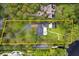 Aerial view of estate featuring lush grounds, pool, circular driveway, and private location at 1550 Bluewater Run, Chuluota, FL 32766