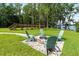 Backyard fire pit with chairs, with a view of the lake at 1550 Bluewater Run, Chuluota, FL 32766