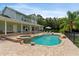 Gorgeous backyard featuring a pool with waterfall, integrated hot tub, and extensive brick patio at 1550 Bluewater Run, Chuluota, FL 32766