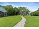 Picturesque backyard with a stone walkway leading to a lake at 1550 Bluewater Run, Chuluota, FL 32766