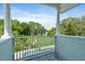 Scenic balcony overlooking a pool, fenced yard, and water views beyond at 1550 Bluewater Run, Chuluota, FL 32766
