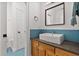 Charming bathroom with blue tiled backsplash, stylish vessel sink and wood vanity at 1550 Bluewater Run, Chuluota, FL 32766