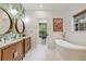 Well-appointed bathroom with double vanities and a soaking tub with views at 1550 Bluewater Run, Chuluota, FL 32766