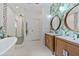 Modern bathroom featuring double vanities, a soaking tub, and a walk-in shower at 1550 Bluewater Run, Chuluota, FL 32766