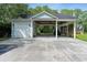Detached garage with a carport featuring a concrete driveway and ample parking space at 1550 Bluewater Run, Chuluota, FL 32766