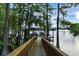 Picturesque wooden dock leading to a covered boat house on a tranquil lake surrounded by trees at 1550 Bluewater Run, Chuluota, FL 32766
