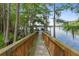 Stunning waterfront view from the wooden walkway leading to a private boat dock at 1550 Bluewater Run, Chuluota, FL 32766