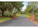Long driveway leading to the house with brick-lined accents and mature trees at 1550 Bluewater Run, Chuluota, FL 32766