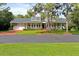 Lovely two-story home with a welcoming front porch, brick driveway, and green lawn for curb appeal at 1550 Bluewater Run, Chuluota, FL 32766