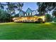 Beautiful home with a wrap-around porch and lush landscaping, bathed in the soft glow of evening lights at 1550 Bluewater Run, Chuluota, FL 32766