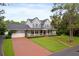Traditional two-story home with inviting front porch and manicured lawn, perfect for Gathering living at 1550 Bluewater Run, Chuluota, FL 32766