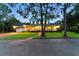 Charming two-story home with a brick driveway, attached garage, and inviting front porch with detailed columns at 1550 Bluewater Run, Chuluota, FL 32766