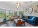 Elegant living room featuring designer wallpaper, hardwood floors, and ample natural light at 1550 Bluewater Run, Chuluota, FL 32766