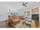 Spacious living room with hardwood floors, fireplace, leather furniture, and an open floor plan to the dining area at 1550 Bluewater Run, Chuluota, FL 32766