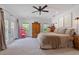 Bright main bedroom features a ceiling fan, large windows, and ample space at 1550 Bluewater Run, Chuluota, FL 32766