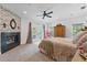 Spacious main bedroom featuring a cozy fireplace and access to a private outdoor space at 1550 Bluewater Run, Chuluota, FL 32766