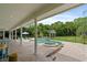 Inviting covered patio overlooking a sparkling pool and spa, surrounded by lush greenery and mature trees at 1550 Bluewater Run, Chuluota, FL 32766