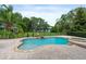 Beautiful backyard pool and spa area with lush landscaping and serene lake views at 1550 Bluewater Run, Chuluota, FL 32766