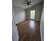 This bedroom features a high ceiling with fan, one window and sleek wood-look floors at 1710 Canoe Creek Rd, Oviedo, FL 32766