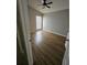This bedroom features a ceiling fan, window and sleek wood-look floors at 1710 Canoe Creek Rd, Oviedo, FL 32766