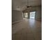 Spacious living room with tile flooring, leading to a screened-in pool area at 1710 Canoe Creek Rd, Oviedo, FL 32766