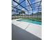 Screened pool boasts a waterfall feature and a white deck in a sunny backyard at 1710 Canoe Creek Rd, Oviedo, FL 32766