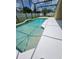 Screened pool area features a white deck, an in-ground pool, and sunny backyard at 1710 Canoe Creek Rd, Oviedo, FL 32766