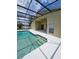 Screened pool area features a covered patio, a white deck, and an in-ground pool at 1710 Canoe Creek Rd, Oviedo, FL 32766