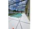 A screened pool area features a white deck, a fence, and a sunny backyard at 1710 Canoe Creek Rd, Oviedo, FL 32766