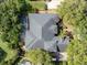 Aerial view of a home showcasing its roof, pool, backyard, landscaping, and surrounding trees at 2046 Westover Reserve Blvd, Windermere, FL 34786