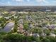 An aerial view of a neighborhood featuring large homes, mature trees, and a peaceful lake at 2046 Westover Reserve Blvd, Windermere, FL 34786