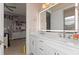 Bright bathroom with dual sinks, framed mirror, and view to the bedroom and glass enclosed shower at 2046 Westover Reserve Blvd, Windermere, FL 34786