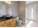 Well-lit bathroom featuring an attractive bowl sink, wood cabinets and shower at 2046 Westover Reserve Blvd, Windermere, FL 34786
