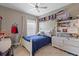 Bright bedroom with ceiling fan, light-colored walls, light-colored wood floors, and a closet at 2046 Westover Reserve Blvd, Windermere, FL 34786