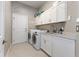 Functional laundry room with ample cabinet space, modern washer, and dryer at 2046 Westover Reserve Blvd, Windermere, FL 34786