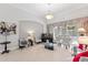 Bright living room with ample seating, glass coffee table, piano, and view of lanai at 2046 Westover Reserve Blvd, Windermere, FL 34786