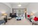 Bright living room featuring a piano, glass coffee table, and large windows at 2046 Westover Reserve Blvd, Windermere, FL 34786