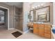 Well-appointed bathroom featuring granite counters, decorative mirrors and glass enclosed shower at 2046 Westover Reserve Blvd, Windermere, FL 34786