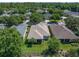 Aerial view of the home with a well-maintained lawn, mature trees, and landscaping at 210 Coleton Lane, Deland, FL 32724