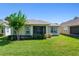 Backyard view showcasing a well-maintained lawn and the home's exterior at 210 Coleton Lane, Deland, FL 32724