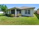 Backyard view showcasing a well-maintained lawn and the home's exterior at 210 Coleton Lane, Deland, FL 32724