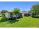 Backyard view showcasing a well-maintained lawn and the home's exterior at 210 Coleton Lane, Deland, FL 32724