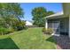 Well-manicured backyard with lush green lawn, screened patio, and beautiful landscaping at 210 Coleton Lane, Deland, FL 32724
