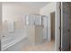 Bathroom features a soaking tub and a glass-enclosed shower at 210 Coleton Lane, Deland, FL 32724