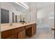 A bathroom shows a double sink vanity and a soaking tub at 210 Coleton Lane, Deland, FL 32724