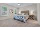 A bedroom has a ceiling fan, two windows, a queen bed, and carpeted floors at 210 Coleton Lane, Deland, FL 32724