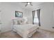 Cozy bedroom with a queen-sized bed, ceiling fan, and a window for natural light at 210 Coleton Lane, Deland, FL 32724